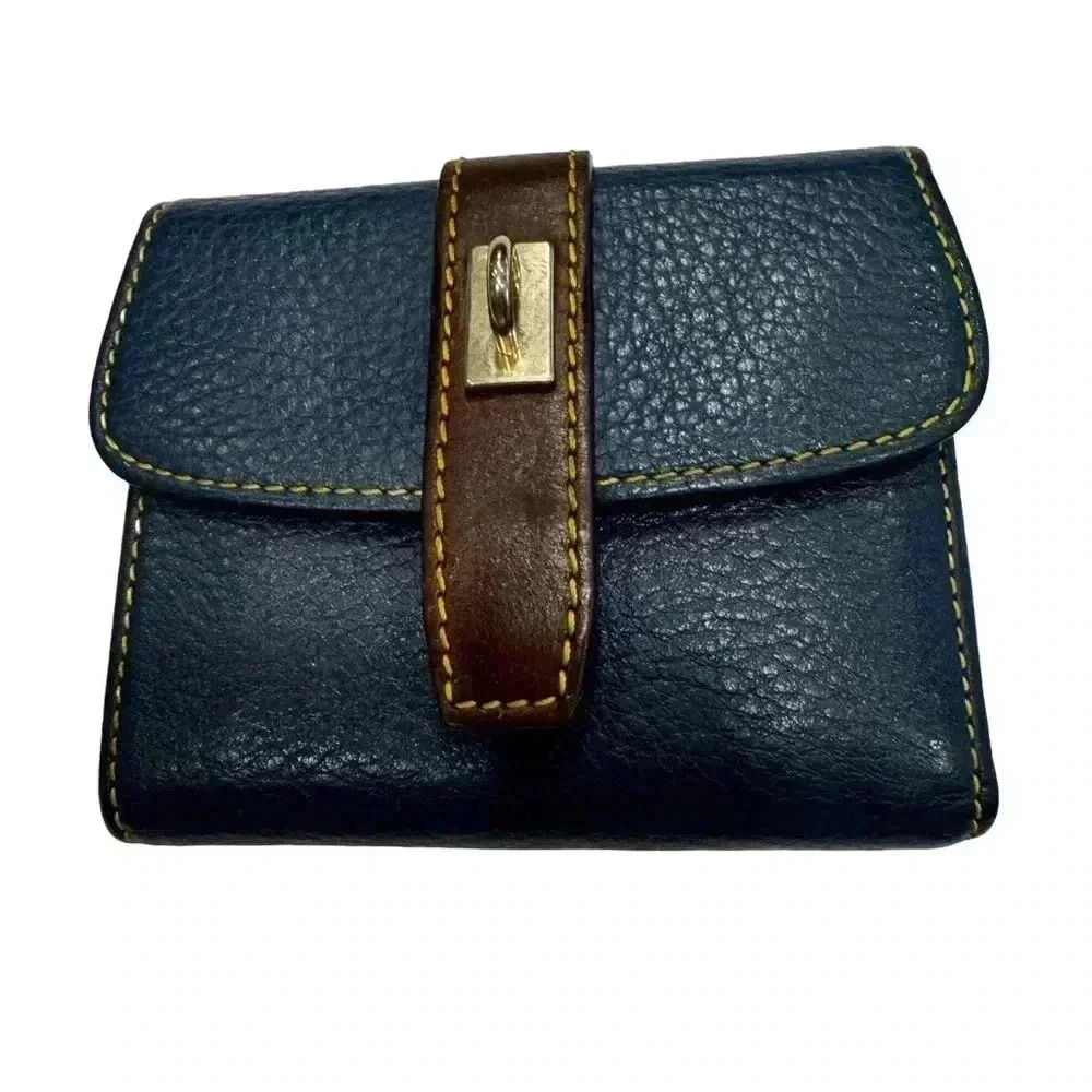 Navy blue pebble leather trifold wallet. Red interior. Perfect condition